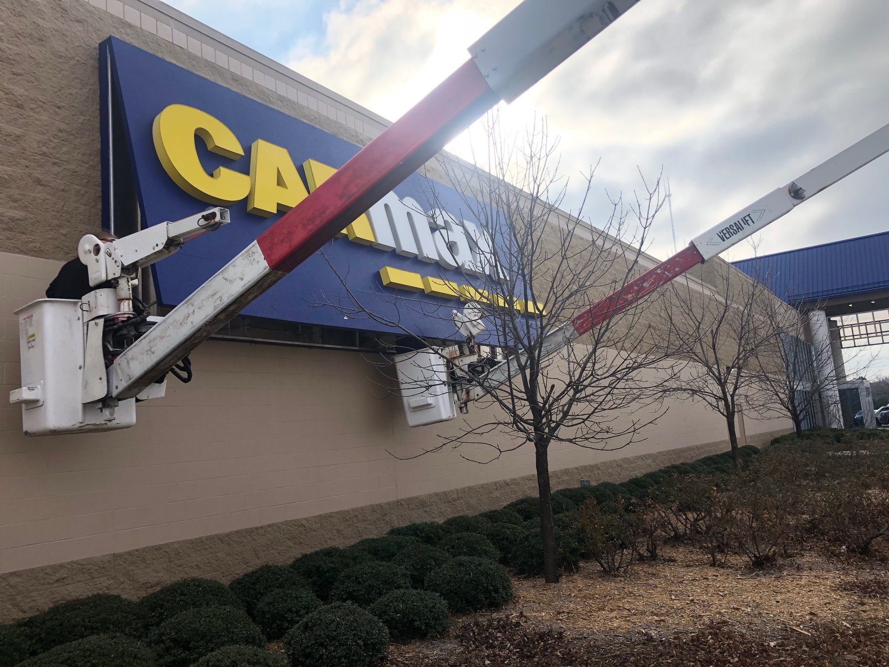 Technician repairing a commercial sign